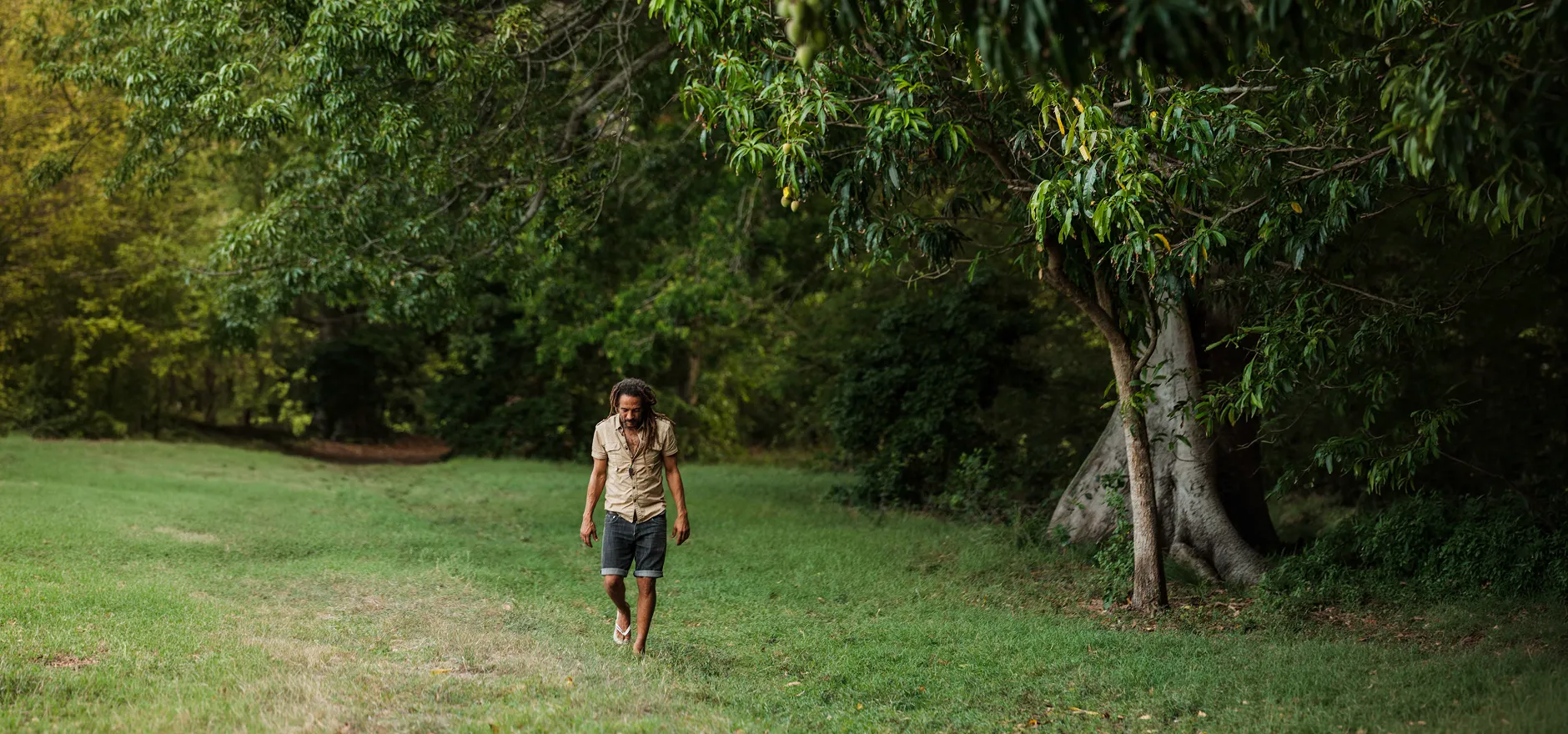 An Antiano participant walking through a green path in Curaçao